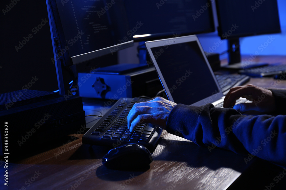 Poster hacker with computers in dark room, closeup. cyber crime