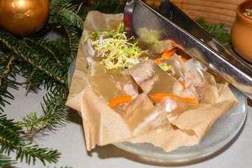 Romanian traditional Christmas food buffet with sorici, caltabos, toba and pork meat cuts, ham