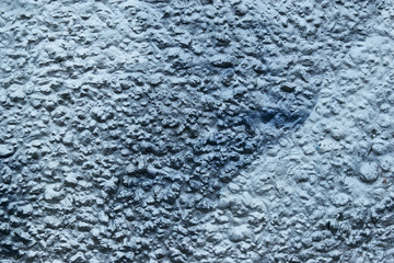 old rough surface of a concrete wall with an uneven coating