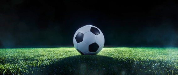 Football on an illuminated sports field at night