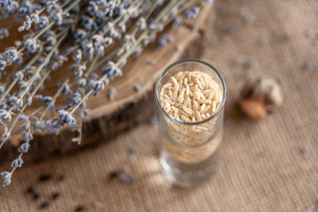 white rice in a glass cup with a bouquet of lavender