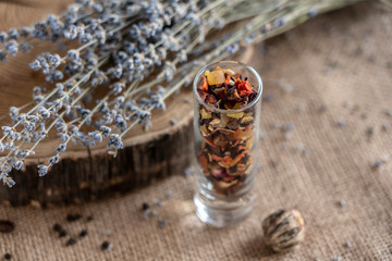 fruit tea in a glass cup with a bouquet of lovanda