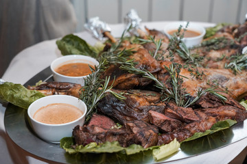 ready-made lamb dish with sauces on a tray