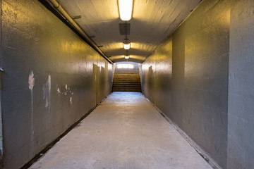 Empty underground tunnel with stairway background. Subway tunnel with outdoor stairs.  - 348353422