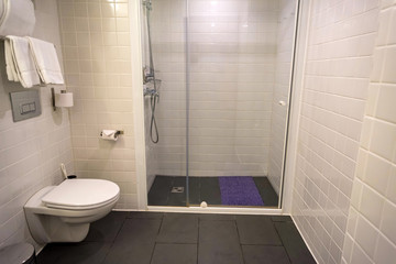 Bathroom in modern hotel with white tile