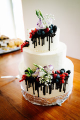 photo of white wedding cake with berries