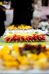 detail of an appetizer based on red cherry tomato and cheese during an event.