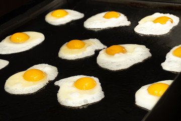 Fried and scrambled eggs and omelette station in a hotel or restaurant setting, catering breakfast