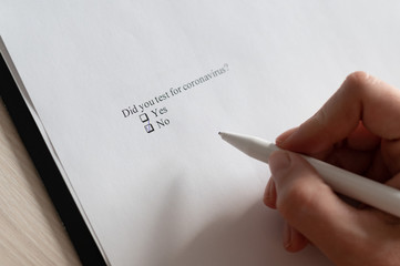 A woman puts a daw in the questionnaire. Close-up of a female hand answering a question about a...