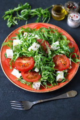 Selective focus. Macro. Salad with arugula, tomato and feta cheese. Nutritious super salad. Keto diet. Keto lunch.