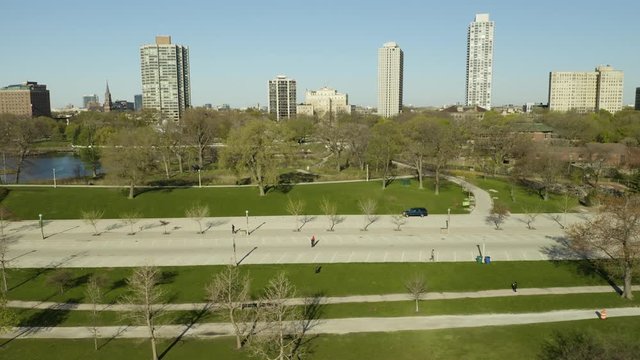 People In City Park Remain Socially Distant While Being Outside, High Rise Buildings In Background, Coronavirus, Aerial