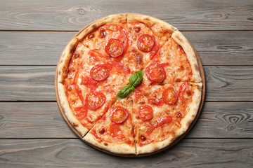 Delicious pizza Margherita on wooden table, top view