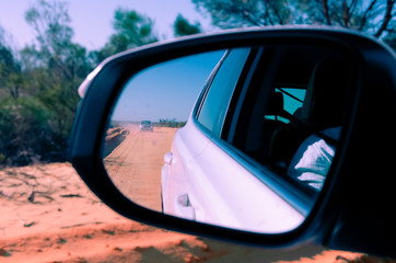 Fototapeta premium Car coming from behind seen in mirror view