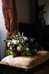 a large bouquet of flowers lies on a soft chair, dim lights, a dark photograph, a bride?s bouquet
