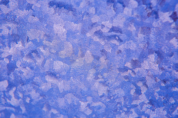 patterns on glass, frosty drawings in winter on a window, blue background and ice drawings, droplets of fody, reflection through glass,