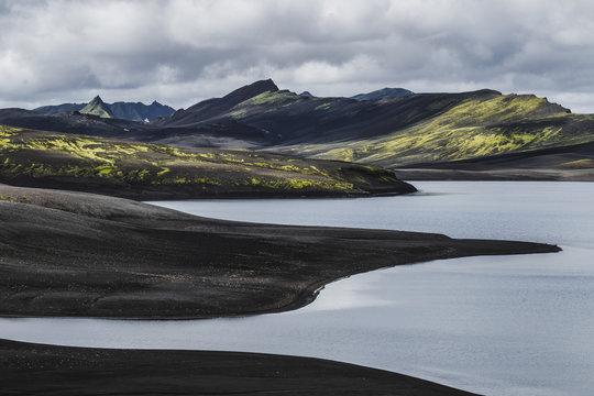 View of Lambavatn lake in Lakagigar volcanic desert in Iceland Skaftafell national park. Landscape with black sand ash and green moss.