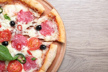 Delicious pizza Diablo on wooden background, top view. Space for text