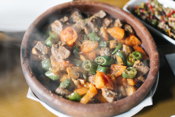 Beef meat with vegetables in casserole stew - Turkish delicious güveç