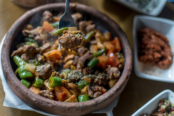 Beef meat with vegetables in casserole stew - Turkish delicious güveç