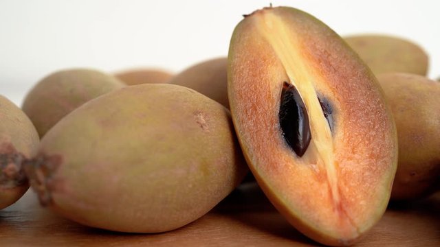 4k Close up, dolly shot of a pile of tropical fruit named Sapodilla
