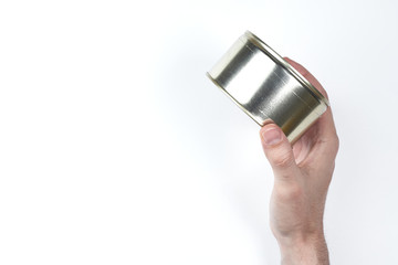 the closed can in the hand on the white background is turned sideways. top view. copyspce. isolated
