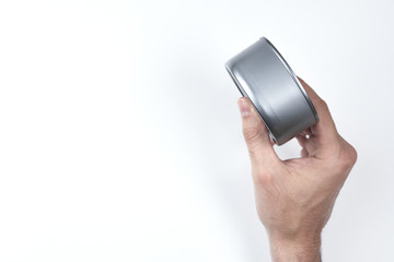 the closed can in the hand on the white background is turned sideways. top view. copyspce. isolated