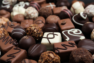 Obraz na płótnie Canvas Different delicious chocolate candies as background, closeup