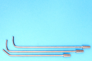 vintage syringe for intrauterine infusions and tonsillectomy on a blue background. copyspace