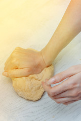 girl makes homemade dough in the kitchen. the concept of home cooking. making homemade dough