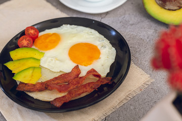 Eggs with avocado, arepa, bacon and tomato with chocolate drink (Colombian breakfast)