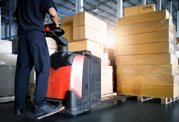 Interior of storage warehouse, Worker with electric forklift pallet jack unloading pallet goods, package boxes, warehouse shipping delivery logistic and transport. © Siwakorn1933