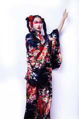Fototapeta premium young pretty geisha in black kimono with sakura, asian ethno closeup on white background isolated