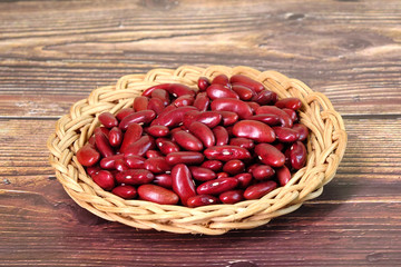 Red kidney beans in basket, selective focus. In Traditional Chinese Medicine Kidney Beans are known for tonify blood and tonify yin, help to clear heat, resolve dampness, and regulate water.
