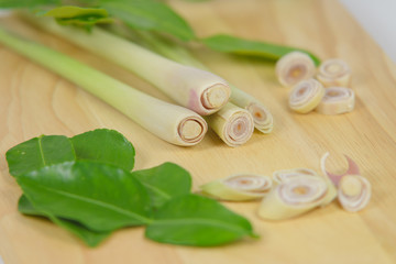 Fresh Lemon grass and leaf of bergamot fruit on wooden board