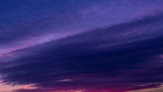 Pink sunset clouds timelapse. Golden hour to blue hour. Colorful tropical beautiful sunset.