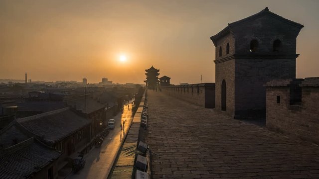 Time lapse of the sun setting over the ancient city wall of Pingyao in China