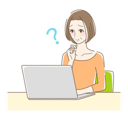 パソコンを操作して悩む女性