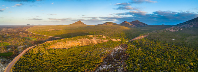 Cape Le Grand National Park in Western Australia - Aerial panorama of some of the granite peaks, hills and bush fire effected area in the national park near the beach camp site near a granite bluff. 