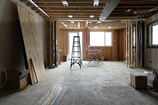 Renovation at residential house in Toronto, Ontario. Tools and wood supply are present on the floor. Steel beams and lighting plates are visible.