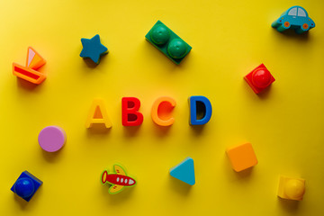 children's letters abcd on a yellow background top view