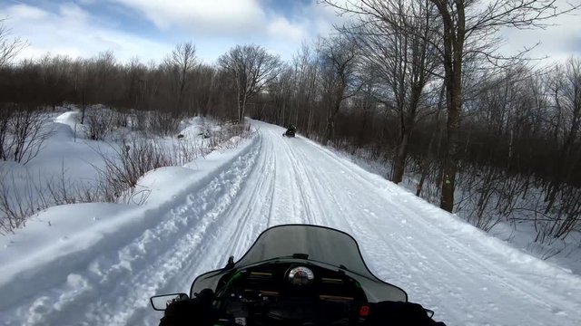 Snowmobiling POV Through Woods