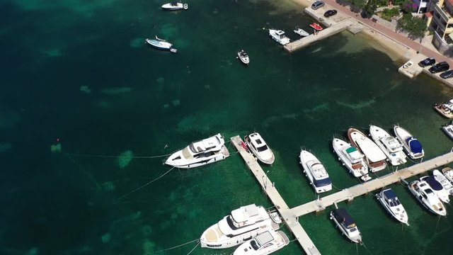 Mediterranean settlement Barbat, with natural habour and boats at berth, Island of Rab, Croatia - Aerial View