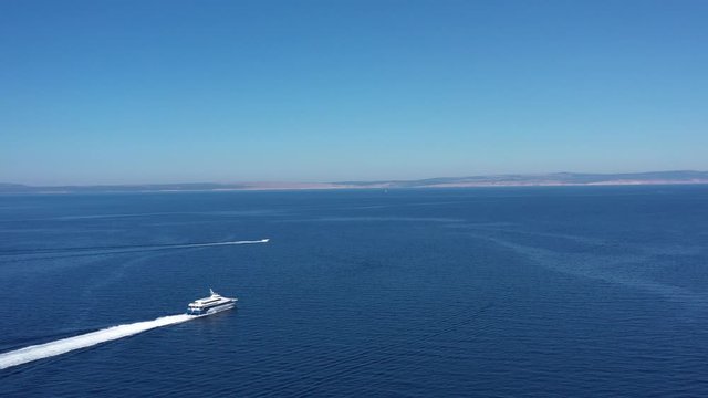 Cruiser Catamaran Ship navigating over beautiful Blue Sea on sunny day - Aerial Panoramic View