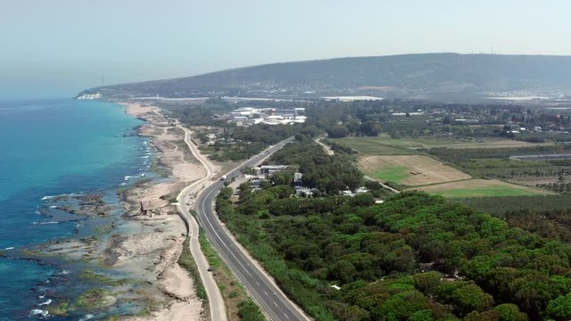 The Israeli coast of the Mediterranean Sea. Near the Banana Beach. Aerial shot in the daytime. UHD video