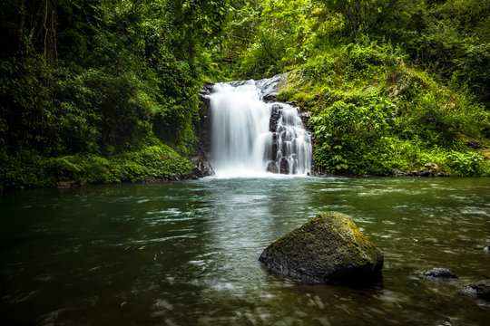 Waterfall landscape. Beautiful hidden Canging waterfall in tropical jungle in Sambangan, Bali. Slow shutter speed, motion photography.