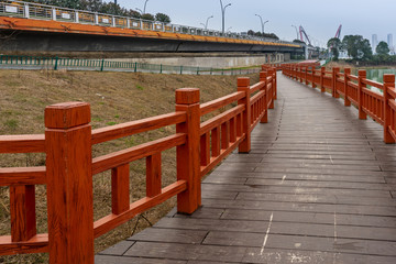 Wooden bridge over little river in city park