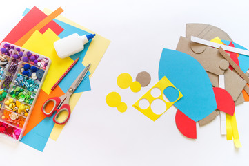 Fototapeta na wymiar Rocket craft made of cardboard and paper. Recycling children's creativity.