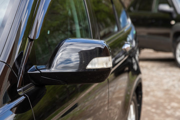 Side mirror of a blue  car close-up. Exterior detail