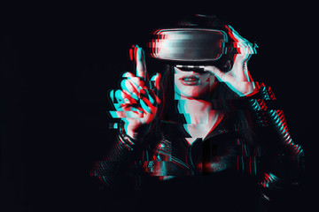 girl wearing virtual reality glasses touches an imaginary projection screen with her finger