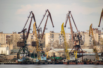 Fototapeta na wymiar Port cranes carry out loading and unloading of trains and sea transport.